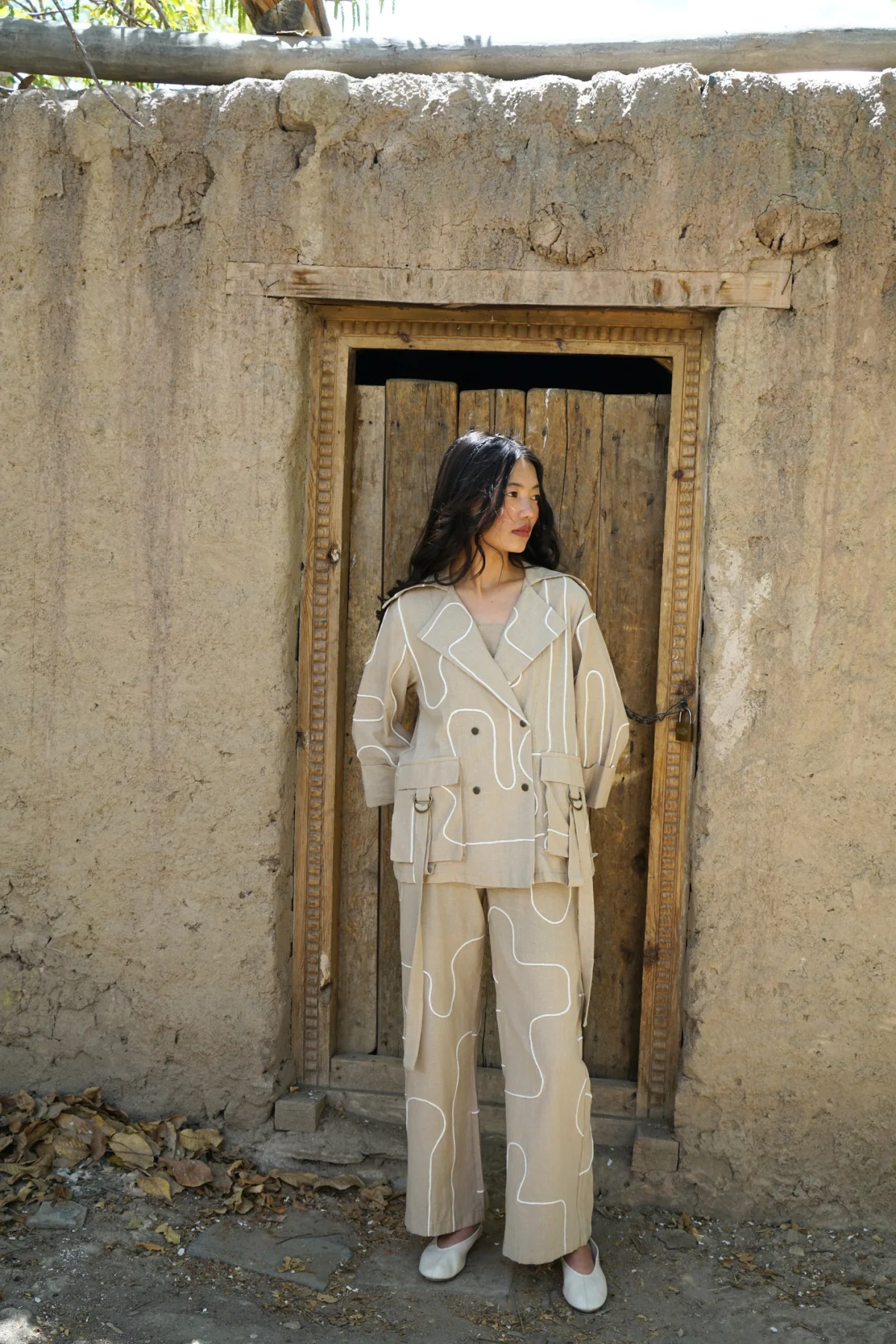 Model wearing a soft neutral tailored look from Echoes of the Valley